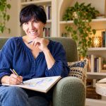 Indigo Children: Where the Idea Came From, What It Gets Right, and Why the “Misdiagnosed” Claim Is Harmful A woman with short dark hair sketches in a notebook from a sage armchair beside an open book and tablet.